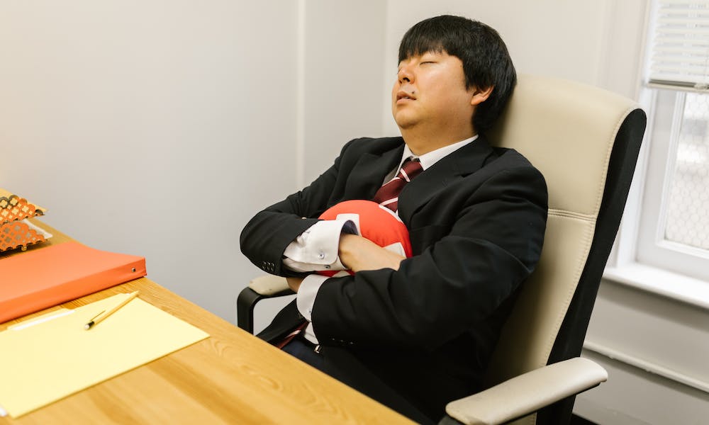 man resting on office chair